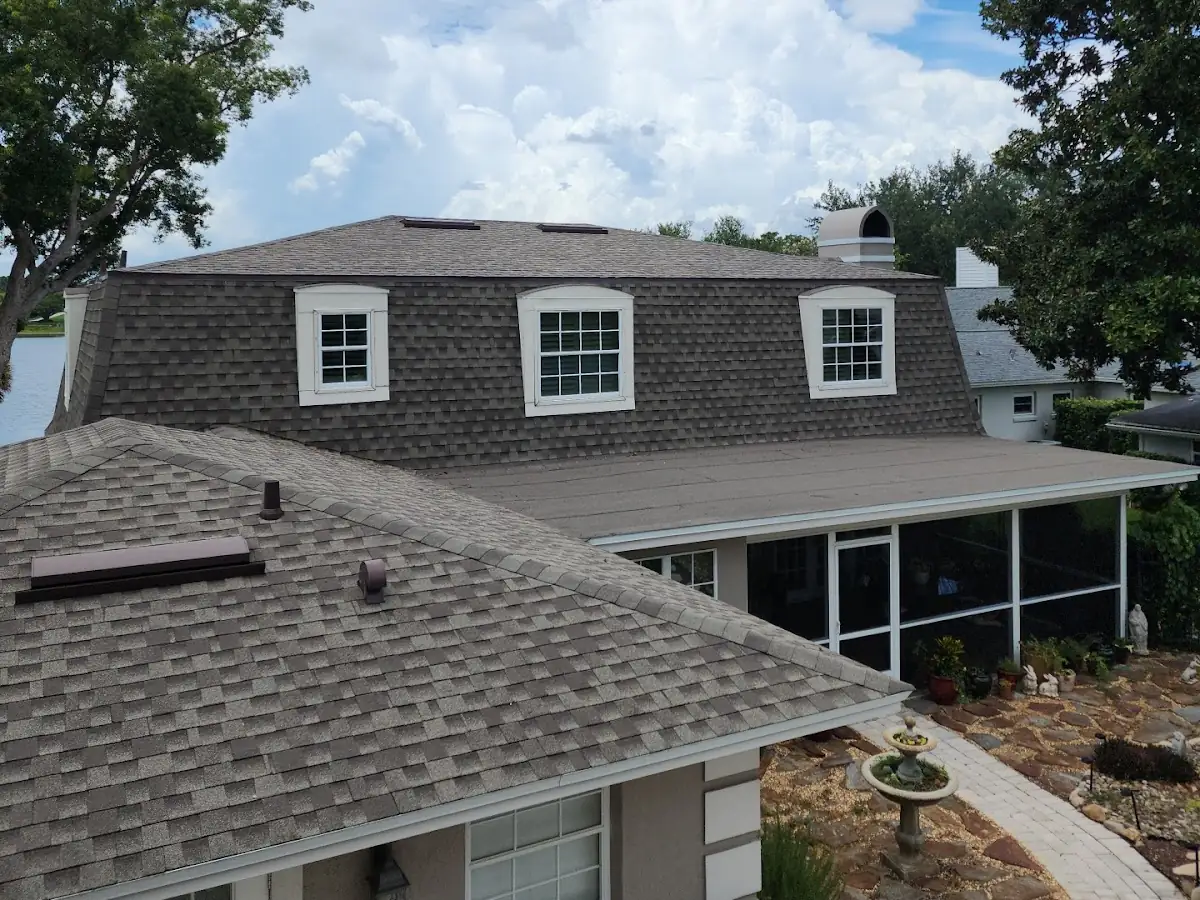 Finished architectural shingle roof on a two-story home, with a low-slope roof over the screened porch