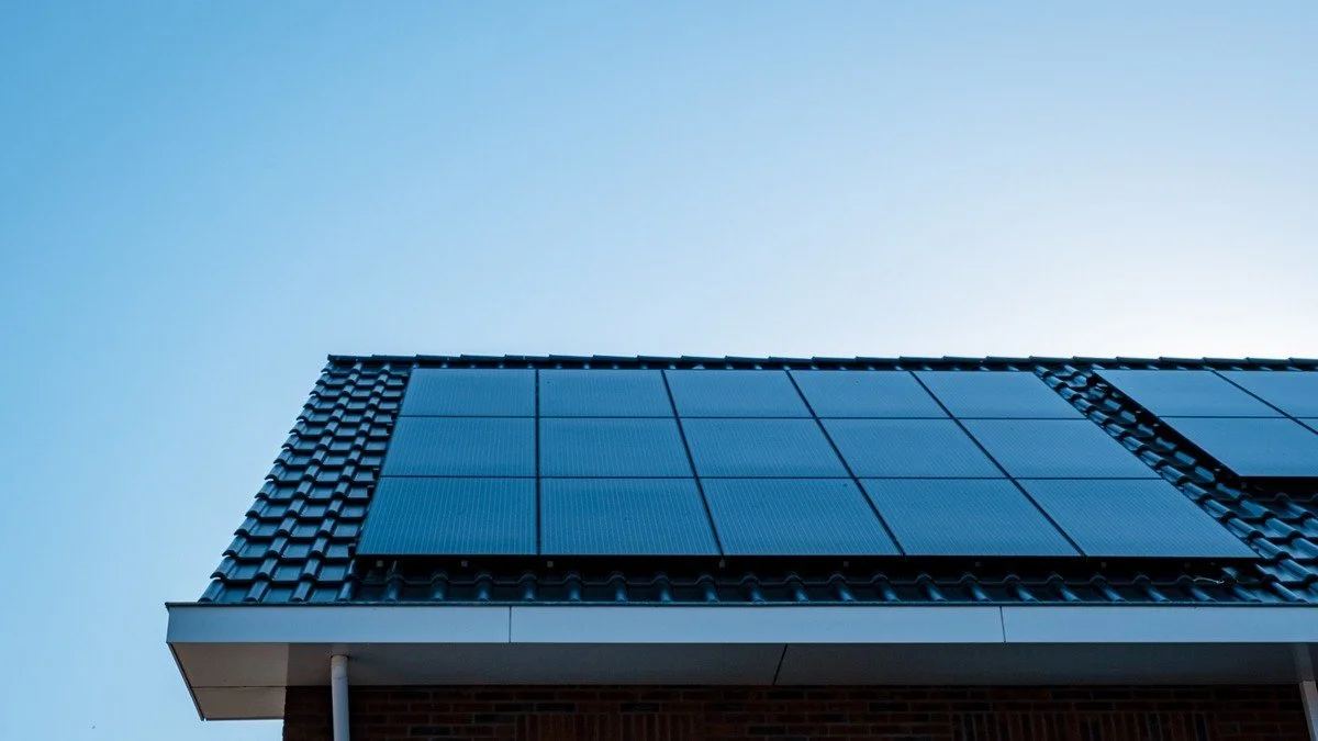 Black solar panel array on tile roof