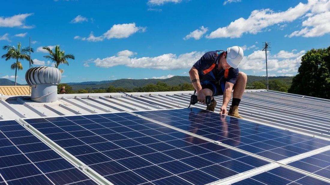 Solar installer on metal roof