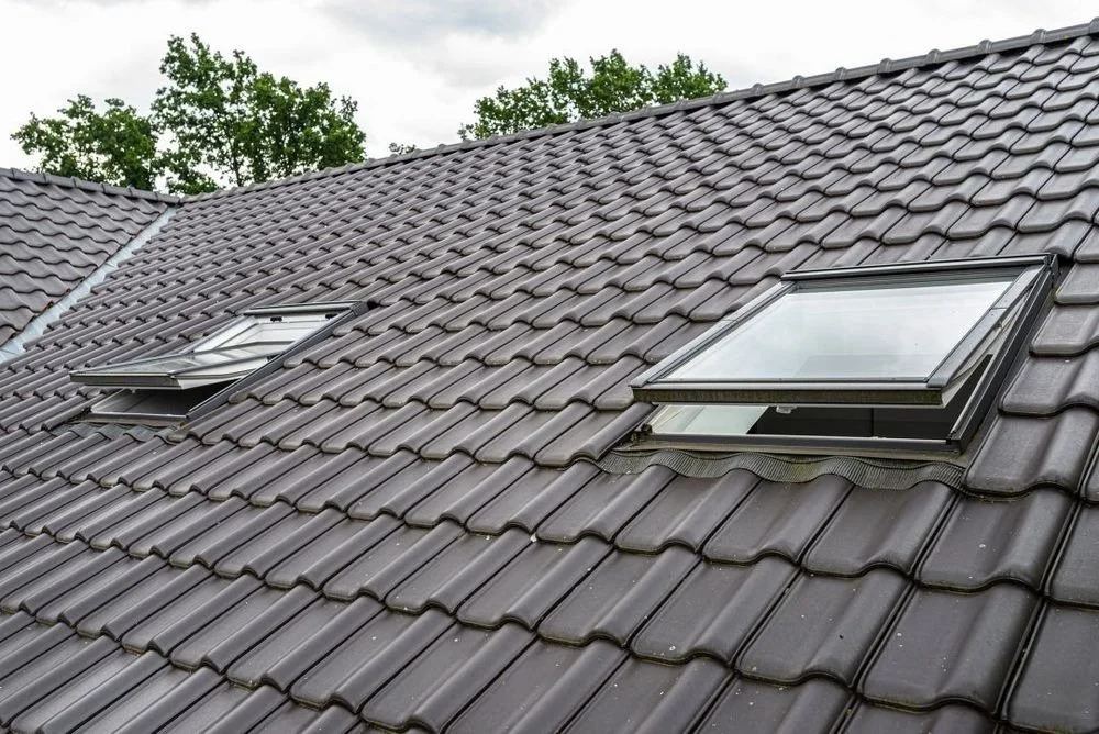 Two open venting skylights on a tile roof